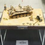 Diorama mit einem Wüstenfahrzeug und Figuren auf einem Acrylsockel
