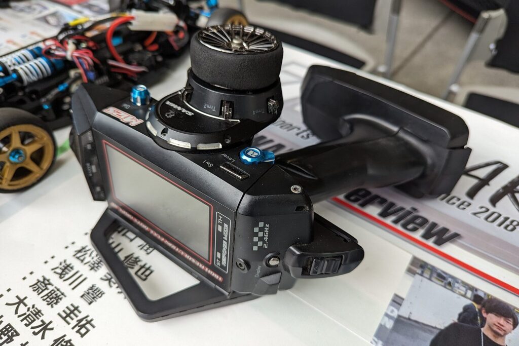 Fernsteuerung für ein RC-Modellauto neben einem Chassis